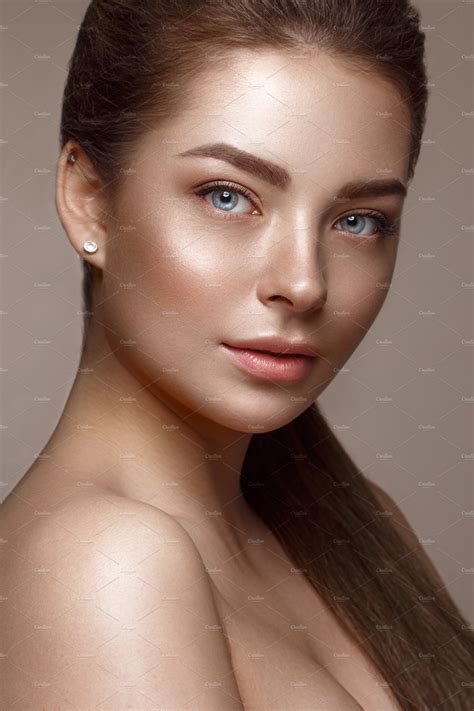 Beautiful young girl with natural nude makeup beauty face featuring