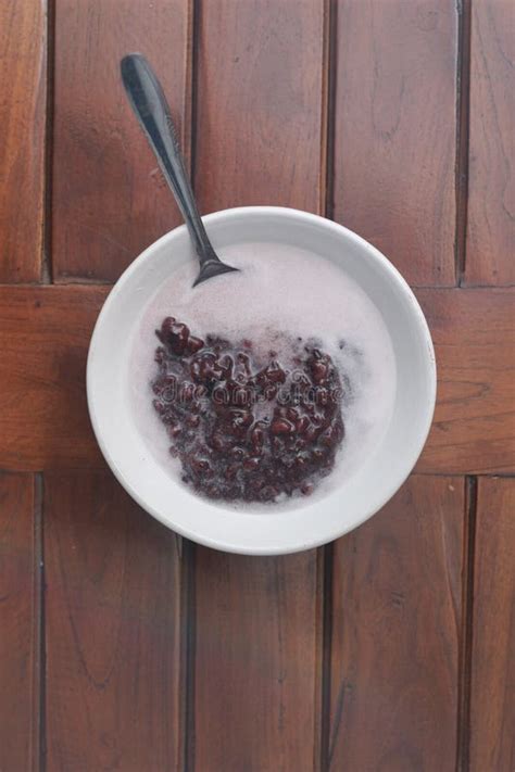 A Bowl of Black Sticky Rice Porridge with Coconut Milk Stock Photo ...