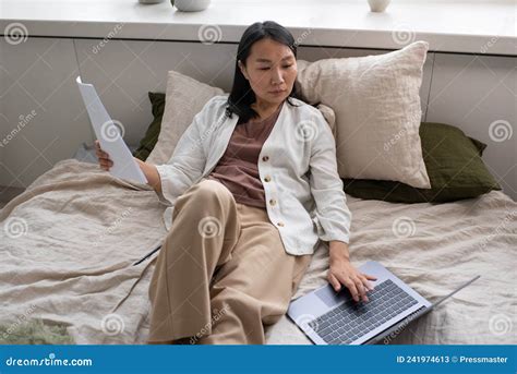 young  female auditor concentrating  work  documents stock