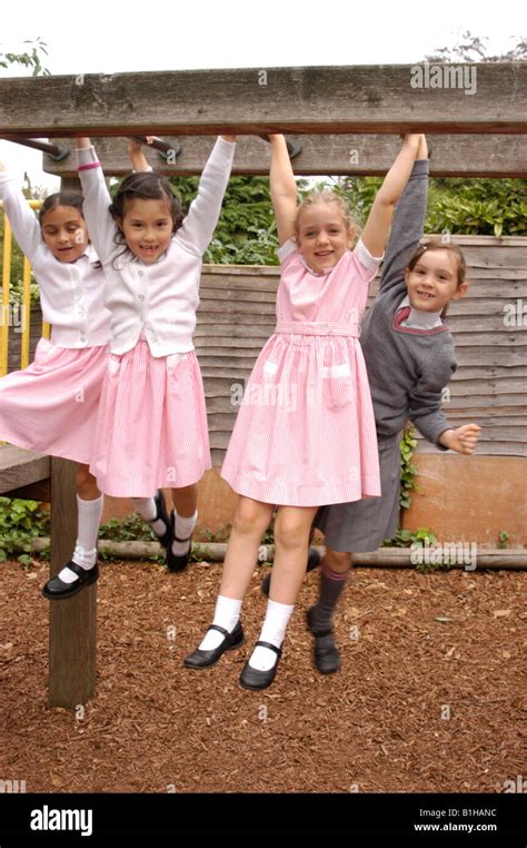 girls on monkey bars in school uniforms Stock Photo - Alamy