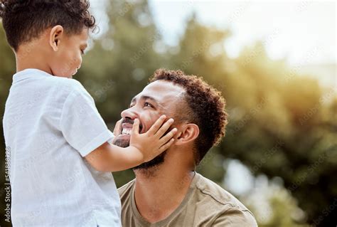 Dad, boy touch face in outdoor park or backyard for summer bonding