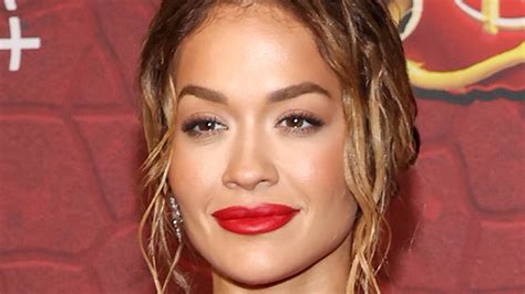Rita Ora is red hot in fiery gown with a sizzling thigh-high slit as ...