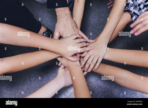 diversity kids hands together on globe team Stock Photo - Alamy