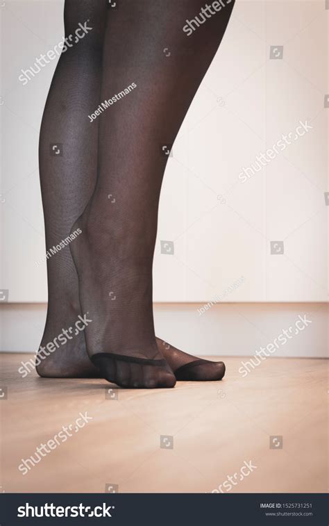 elegant portrait feet girl black pantyhose stock photo