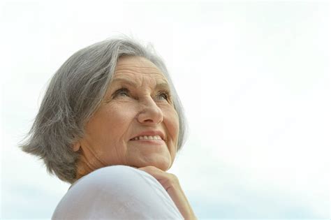 Download White Top Beautiful Older Woman Wallpaper | Wallpapers.com