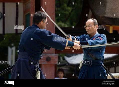 Two men engaged in a sword fight using real samurai swords during a ...