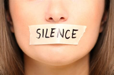 Premium Photo | A female face with a tape on her mouth and a notice ...
