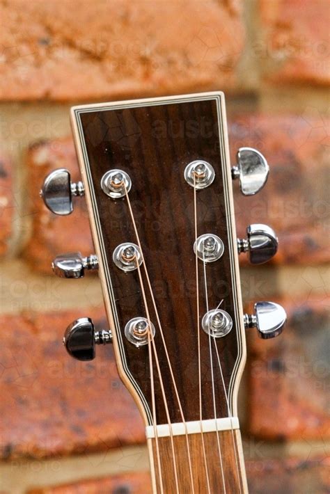 Image of Acoustic guitar headstock showing string tuners. - Austockphoto