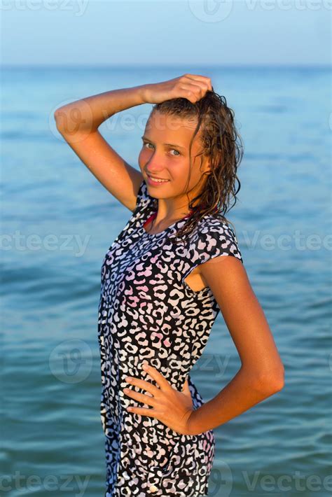 attractive teen girl in wet dress 18949763 Stock Photo at Vecteezy