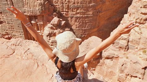 Caucasian tourist traveler sitting joyful on viewpoint in Petra ancient