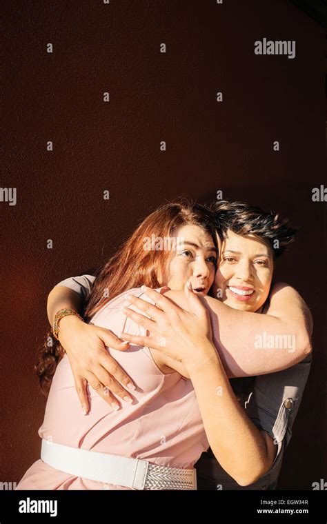 Two friends hugging Stock Photo - Alamy