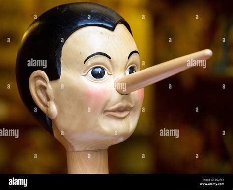 Wooden pinocchio doll with his long nose Stock Photo - Alamy