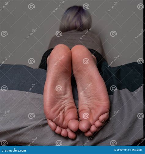 Closeup of the Soles of Female Feet Lying in a Bed Stock Image - Image