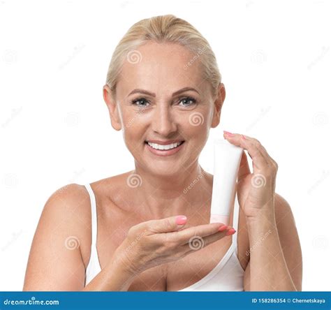 Portrait of Beautiful Mature Woman with Perfect Skin Holding Tube of