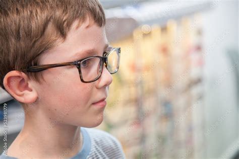 Young boy trying on different frames for new glasses Stock Photo ...