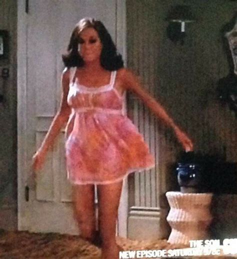 a woman in a pink dress is walking through a room with an open door and ...