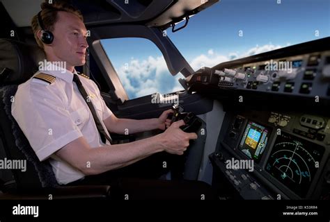 side view  young male pilot flying airplane  cockpit stock photo