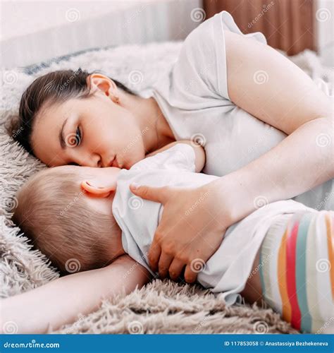 Mother and Baby Boy Sleeping Together on Bed Stock Photo - Image of