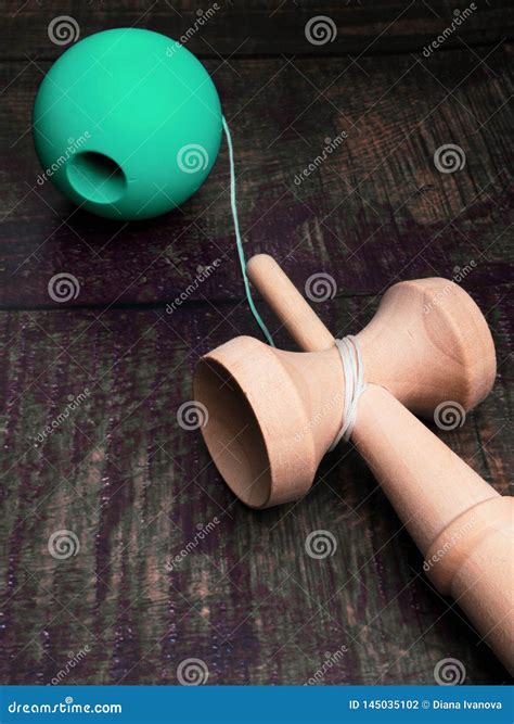 Traditional Japanese Wood Toy Kendama on Wooden Background, Symbol of