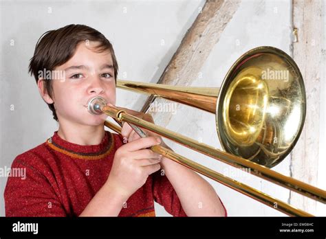 Boy playing the trombone hi-res stock photography and images - Alamy