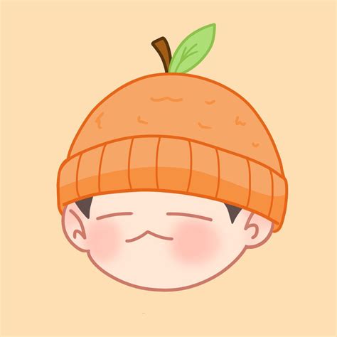 an orange hat with a green leaf on it's top and a smiling face