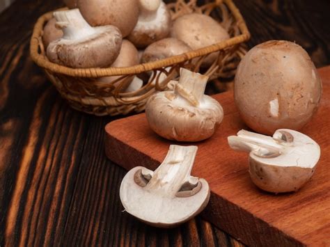 premium photo champignon mushrooms   wooden table