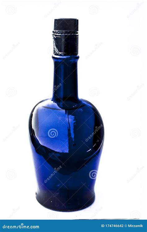close   blue colored bottle  brandy  whiskey  cognac isolated