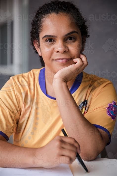 Image of Portrait of Aboriginal woman with pen and paper - Austockphoto