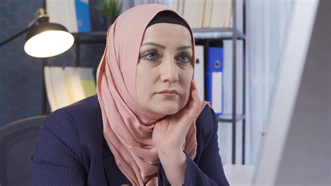 Mature muslim woman working in an office. Business woman in hijab