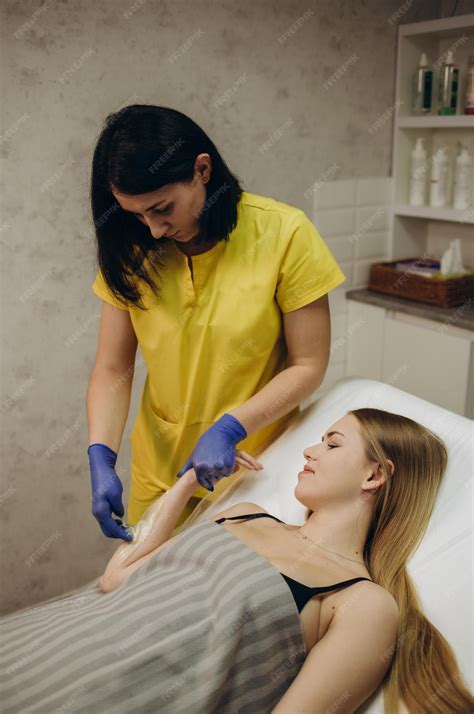 Premium Photo | Waxing Depilation hand and arm of the young woman lying
