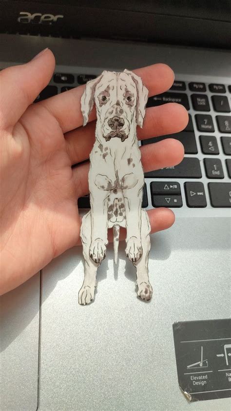 a sticker of a dog sitting on top of a laptop computer's keyboard