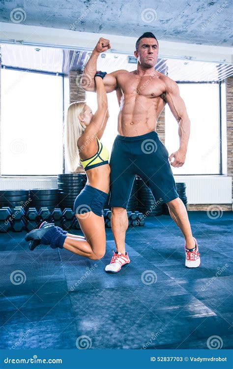 Fit Woman Hanging on a Hand of Muscular Man Stock Image - Image of athletic, lifestyle: 52837703