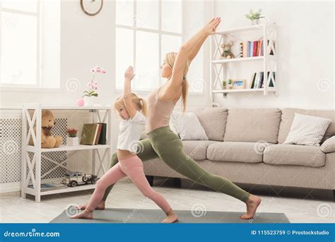 Mother and Little Daughter Doing Yoga Together Stock Image - Image of ...
