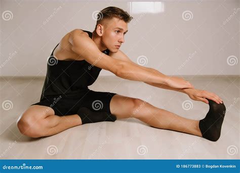 handsome young man  hamstring stretch exercise  home stock image