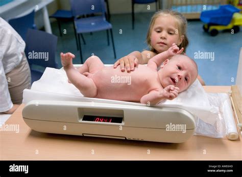 Newborn baby at the scale in the health care centre Stock Photo - Alamy