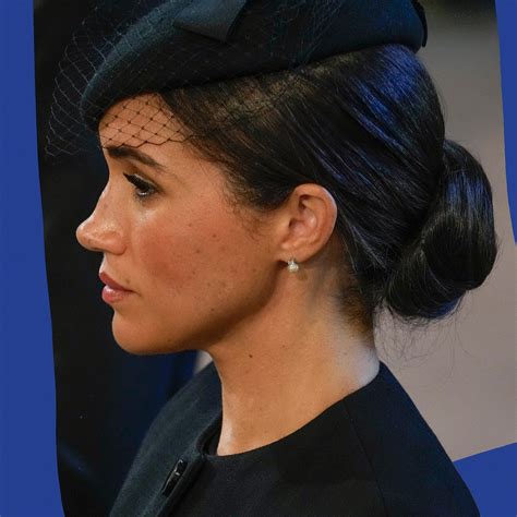 Meghan Markle, Duchess of Sussex, wipes away tears at Queen Elizabeth's