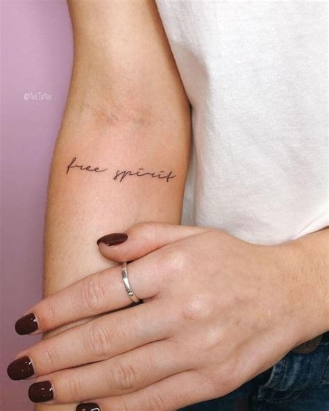 a woman's arm with a small tattoo on it that says, free spirit