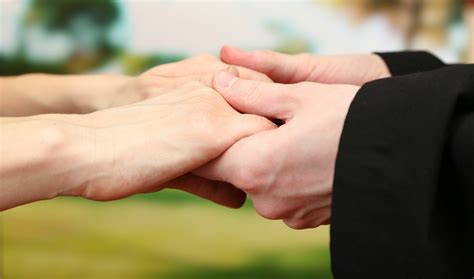hand holding at beautiful funeral - Beautiful Farewells