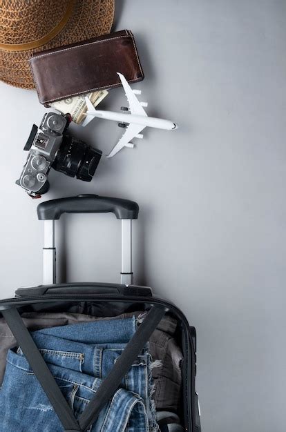 Premium Photo | Open suitcase packed for traveling with thailand ...