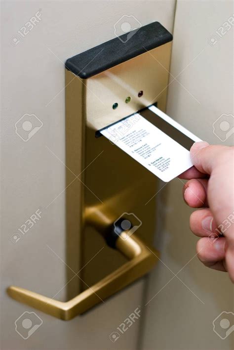 Photo of person's hand inserting a key card into a hotel room ...