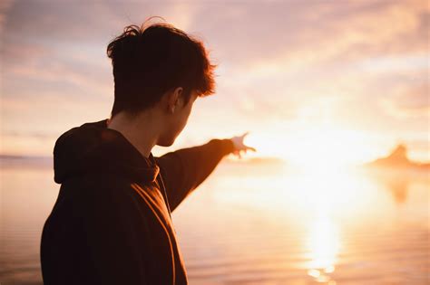 man pointing  sunrise  stock photo