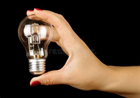 Female Hand Holding Lamp Isolated On The Black Background Stock Photo ...