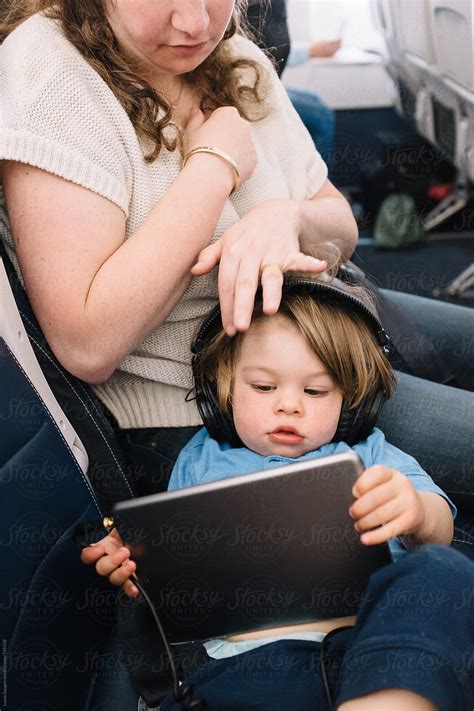 «Mother Brushes The Hair Of Her Son While He Watches A Show On His