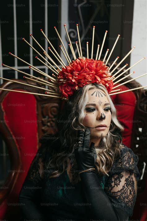 A woman with makeup on her face sitting in a chair photo – Makeup Image