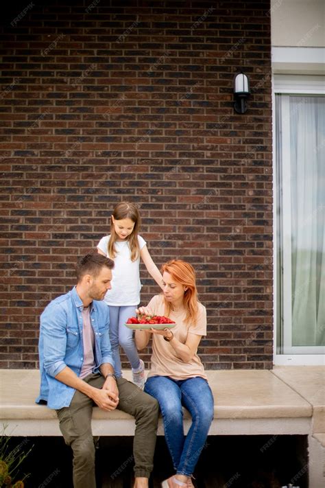 Premium Photo | Family with a mother father and daughter sitting