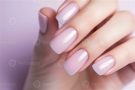 Closeup woman hand with soft pink nail polish on fingernails. Soft pink