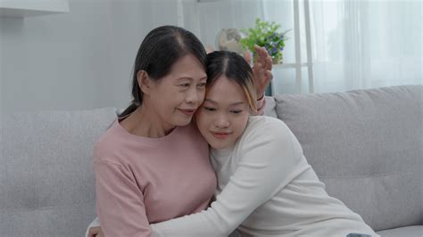 Mother day, cute asian teen girl hugging mature middle age mum. Love
