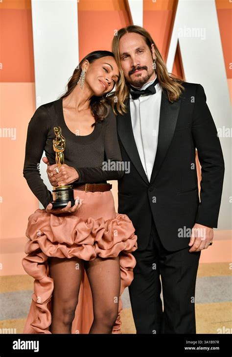Zoe Saldana, left, and husband Marco Perego-Saldana arrive at the ...