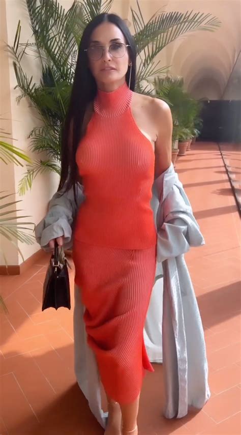 Demi Moore, 60, goes braless in teeny tiny red hot dress as she flirts ...