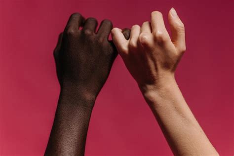 Premium Photo | Two hands with one being held up